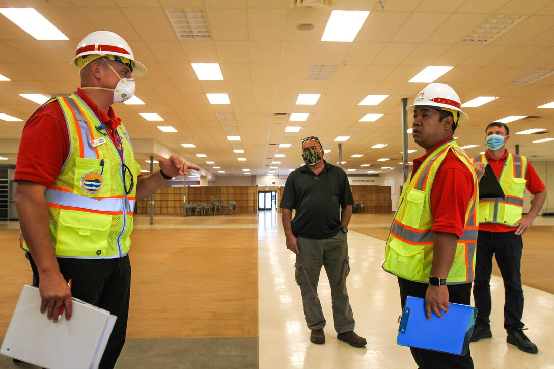Members from the U.S. Army Corps of Engineers (USACE) Honolulu District discuss plans to transform commercial facilities to alternate-care-facilities in Kauai, Hawaii, April 3, 2020.