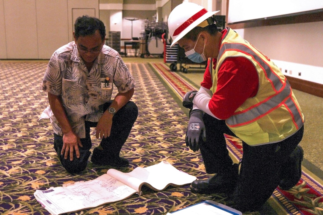A member of the U.S. Army Corps of Engineers (USACE) Honolulu District discusses the layout of a potential COVID-19 alternate-care-facility in Kauai, Hawaii, April 3, 2020.