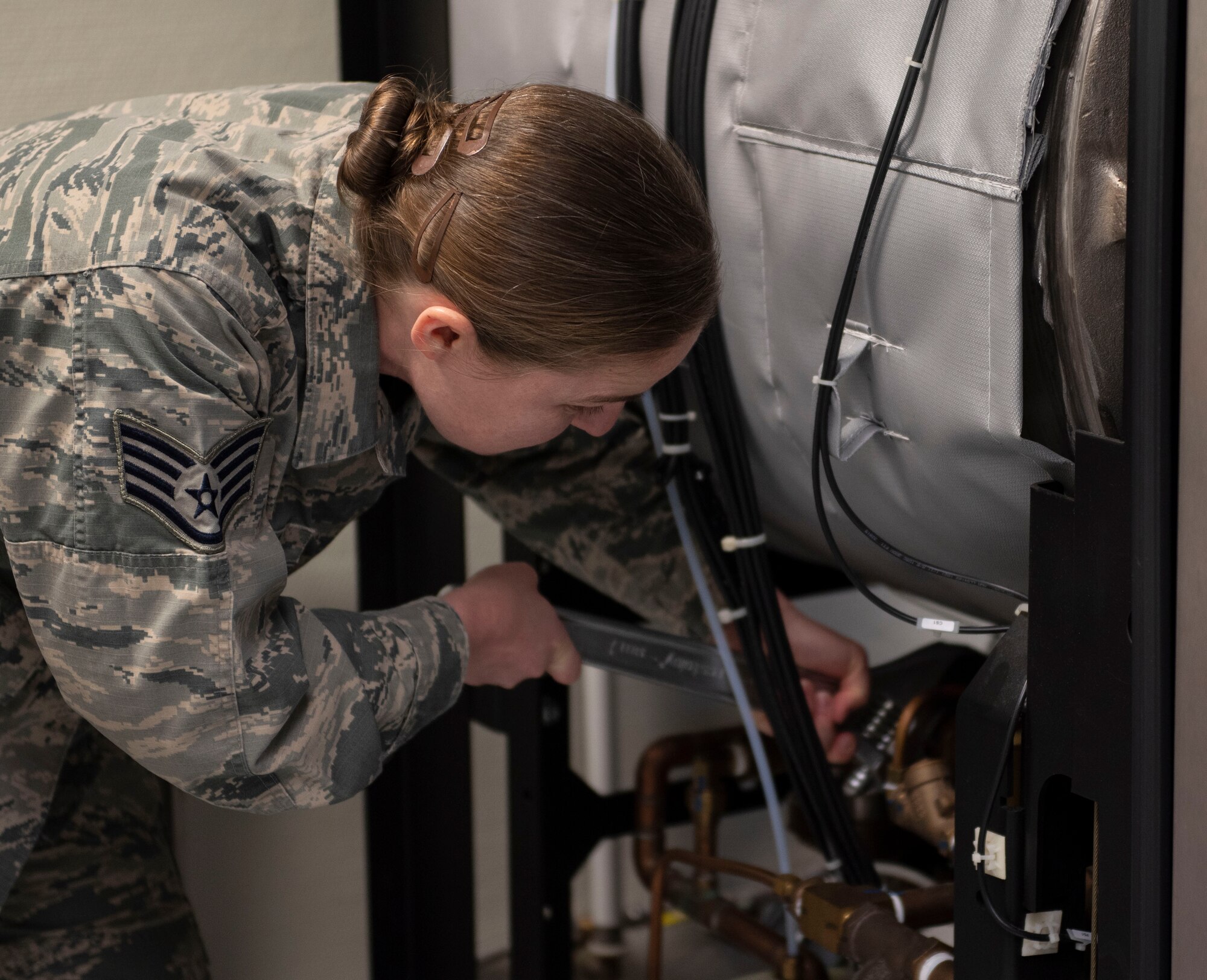 U.S. Air Force Staff Sgt. Heather Merrill, 52nd Medical Group biomedical equipment technician, tightens a bolt on a sterilizer at Spangdahlem Air Base, Germany, April 1, 2020. The sterilizer is the final step medical tools go through before returning to their respective departments. (U.S. Air Force photo by Senior Airman Melody W. Howley)