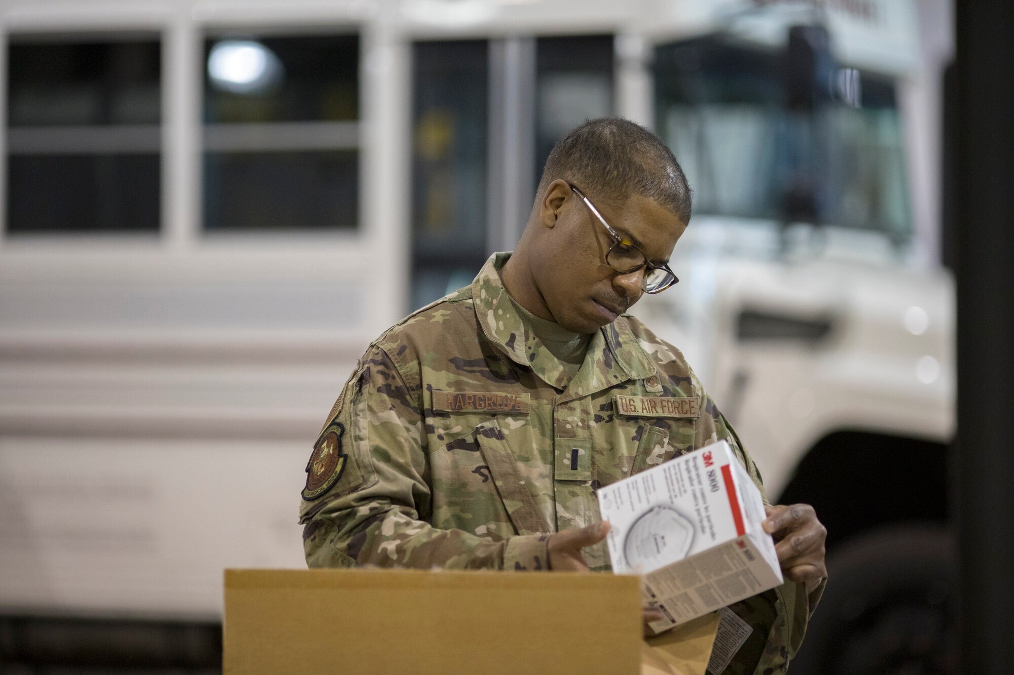 U.S. Air Force 1st Lt. Tyrell Hargrove with the Delaware National Guard inspects personal protective equipment inside Delaware Emergency Management Agency headquarters, Smyrna, Del., March 27, 2020. Hargrove is helping evaluate sites that can be used as acute care facilities should hospitals become overwhelmed with COVID-19 patients.