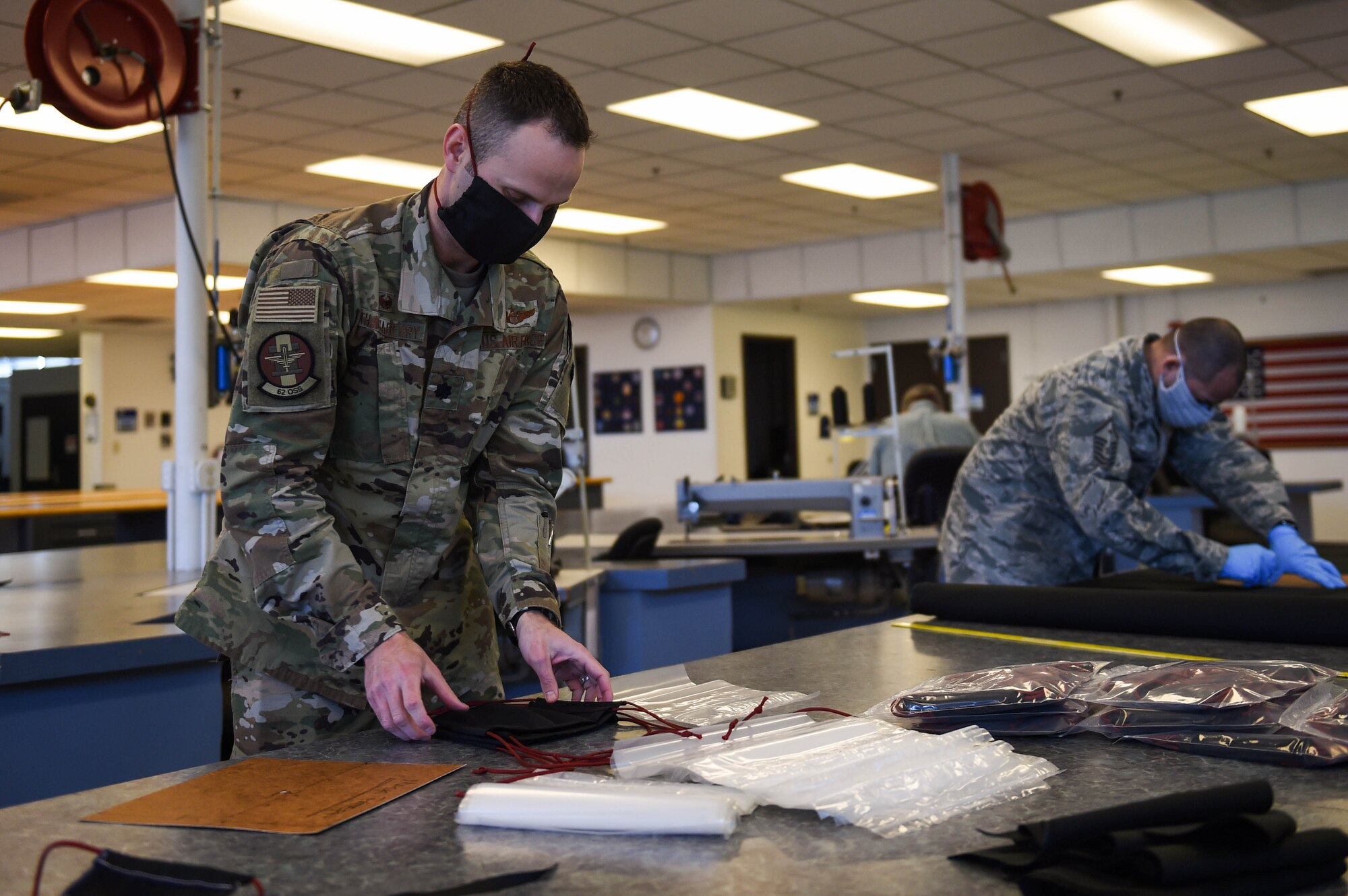 Lt. Col. Chris Thackaberry, 62nd Operations Support Squadron commander, packages completed cloth face masks at the 62nd OSS aircrew flight equipment fabrication shop on Joint Base Lewis-McChord, Wash., April 6, 2020. The masks were distributed first to Airmen who come in contact with aircrews most frequently such as maintainers and AFE Airmen. (U.S. Air Force photo by Airman 1st Class Mikayla Heineck)