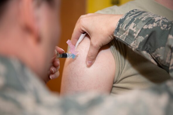 Photo of Airman administering a shot.