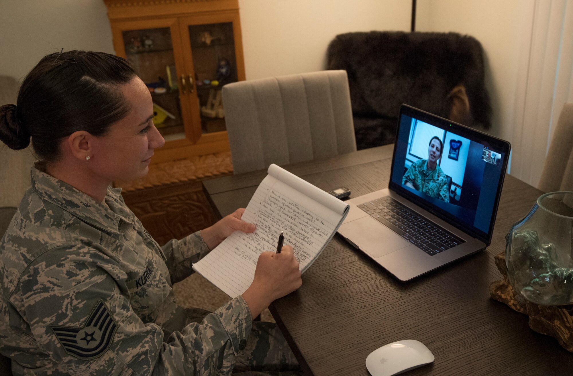 A photo of U.S. Air Force Tech. Sgt. Amber Kurka, 624th Public Affairs photojournalist craftsman, speaking with Col. Athanasia Shinas, the 624th Regional Support Group commander, during a video teleconference interview April 2, 2020, from her home in Mililani, Hawaii, about the unit’s upcoming first-ever virtual unit training assembly. Air Force Reserve Airmen in Hawaii and Guam continued mission readiness training during the 624th RSG virtual UTA, which was implemented to help keep Airmen safe during COVID-19 pandemic. (Courtesy Photo)