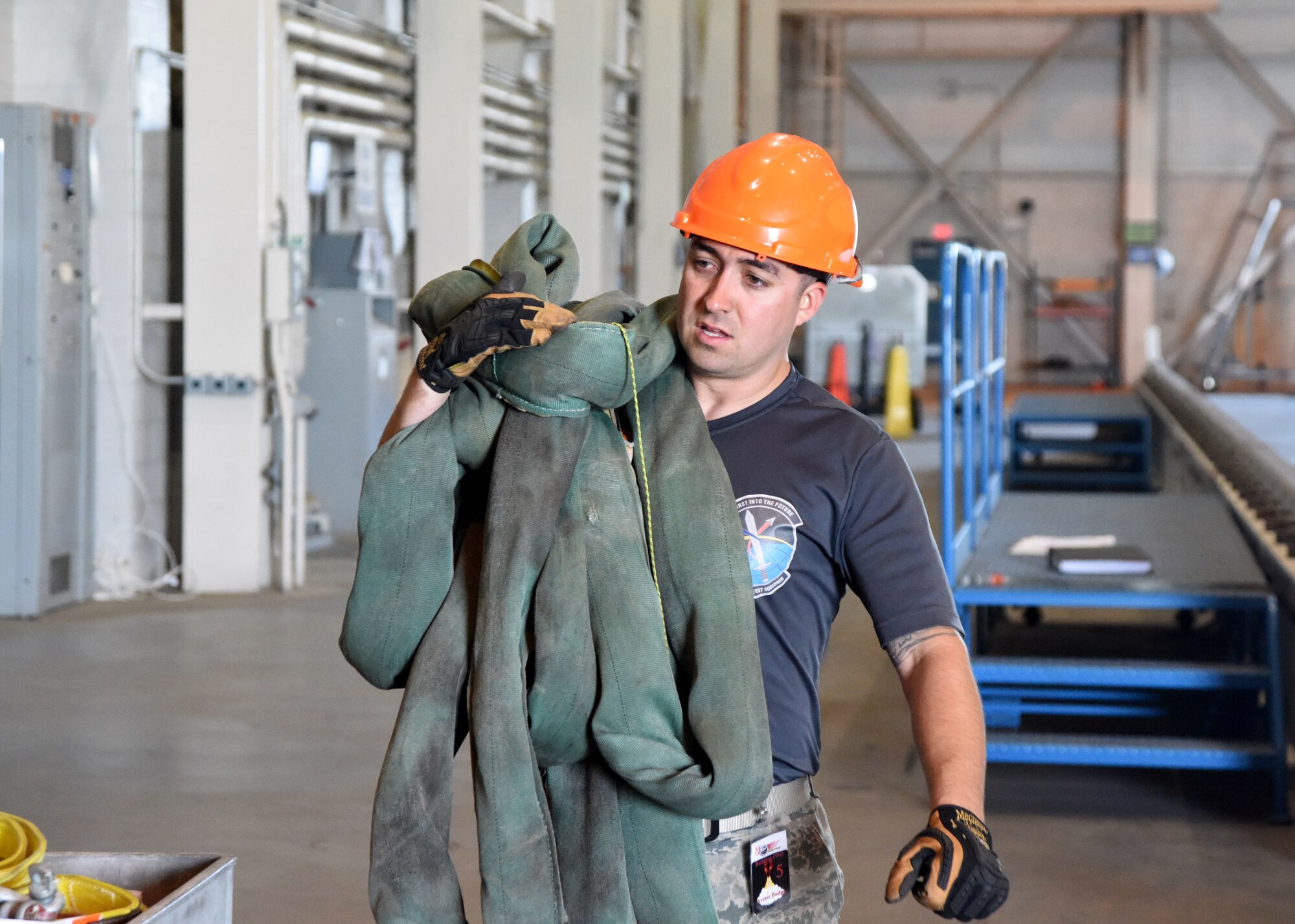 Tech. Sgt. Joseph Lecureux, 2nd Space Launch Squadron NCO in charge of space launch maintenance, carries hardware lifting slings for rocket motor movement July 14, 2017, at Vandenberg Air Force Base, Calif. The 2nd SLS is home to the Space Force’s only hands-on space lift mission in support of the Minotaur launch vehicle. (U.S. Air Force photo by Senior Airman Clayton Wear)