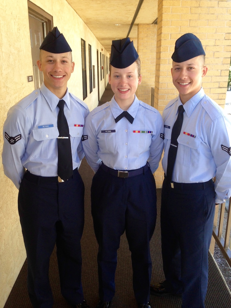 Three Airmen in dress blues uniform