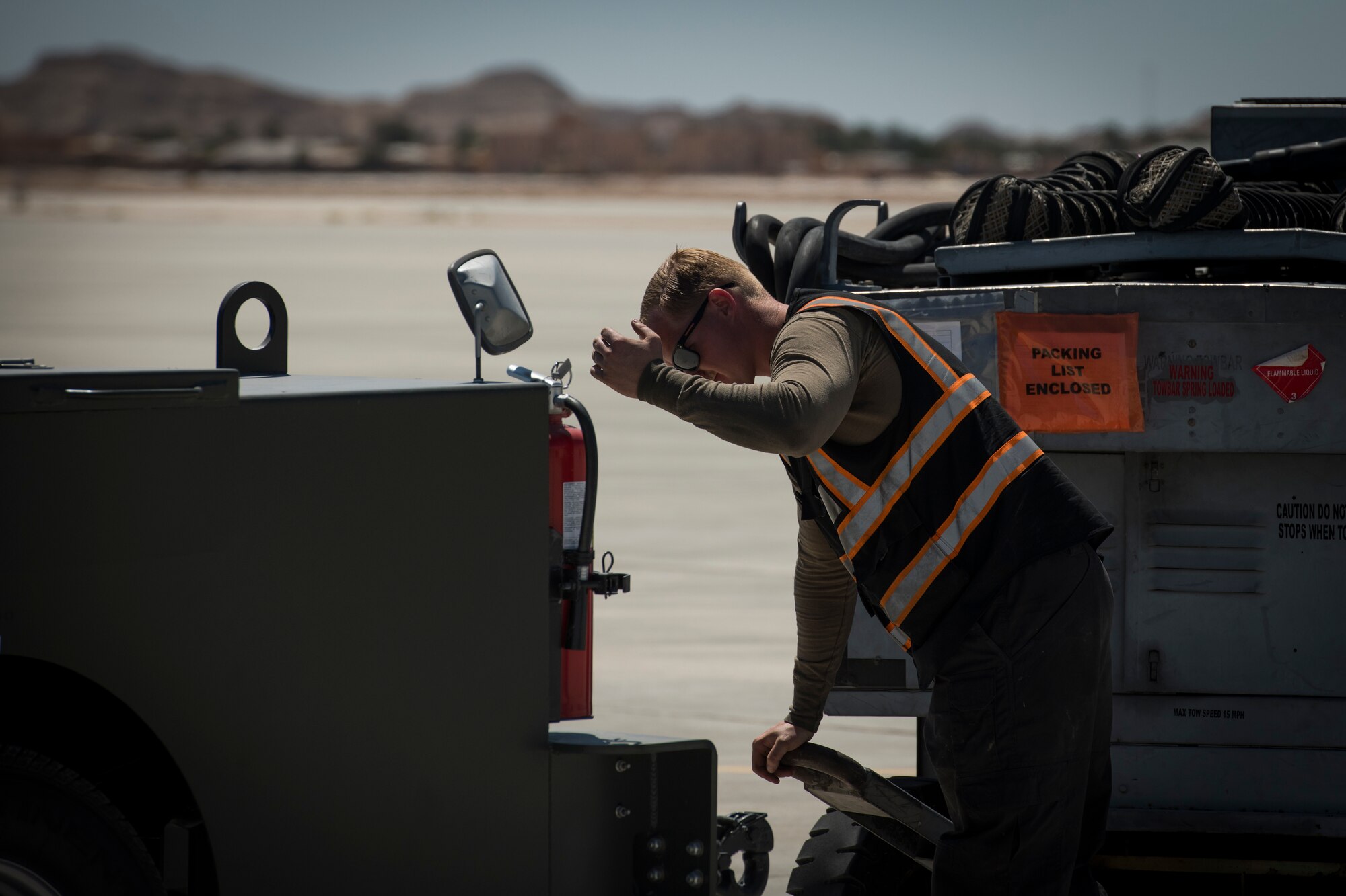 U.S Air Force Staff Sgt. David Williams, a crew chief with the 380th Expeditionary Aircraft Maintenance Squadron, guides a vehicle operator at an undisclosed location in the U.S. Central Command area of responsibility, Feb. 23, 2020.