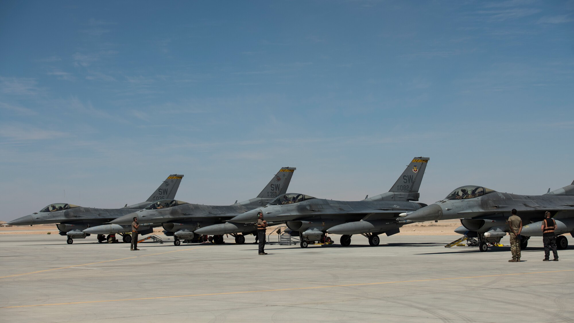 U.S. Air Force Airmen with the 380th Expeditionary Aircraft Maintenance Squadron wait to marshal U.S. Air Force F-16 “Viper” Fighting Falcons assigned to the 79th Expeditionary Fighter Squadron at an undisclosed location in the U.S. Central Command area of responsibility, Feb. 24, 2020.