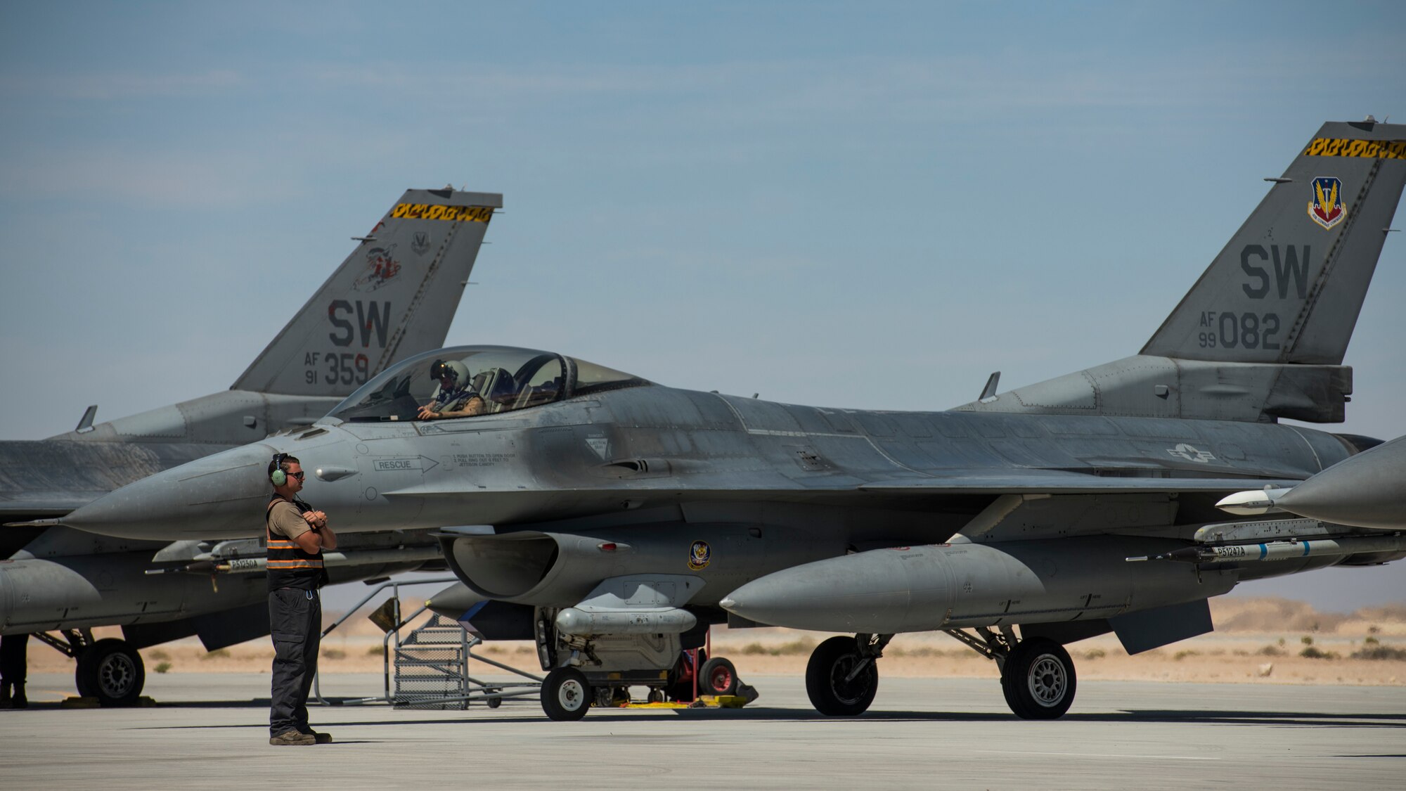 U.S Air Force Senior Airman Steven Kuethe, a crew chief with the 380th Expeditionary Aircraft Maintenance Squadron, waits to marshal a U.S. Air Force F-16 “Viper” Fighting Falcon assigned to the 79th Expeditionary Fighter Squadron at an undisclosed location in the U.S. Central Command area of responsibility, Feb. 24, 2020.