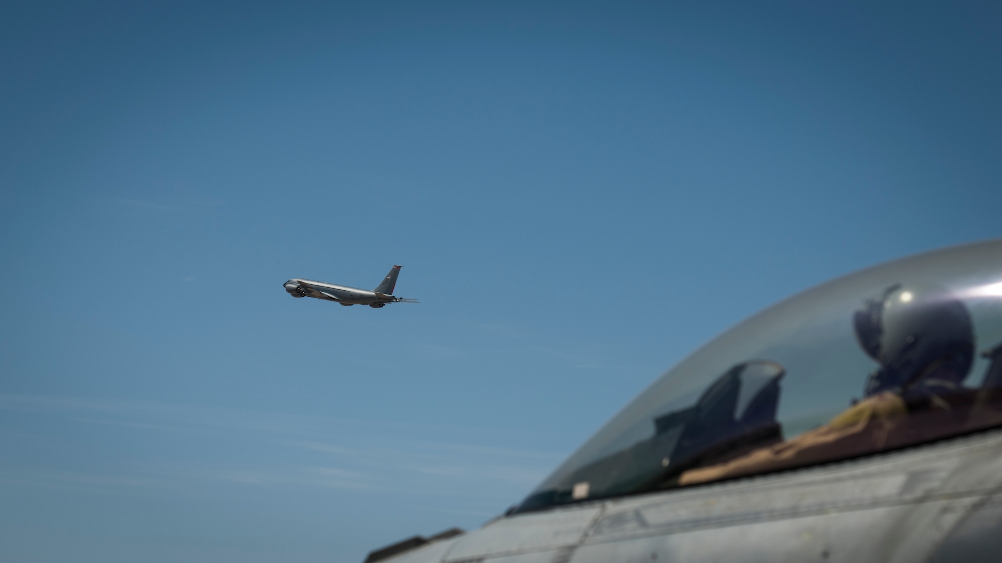 A U.S. Air Force F-16 “Viper” Fighting Falcon pilot assigned to the 79th Expeditionary Fighter Squadron looks on as a U.S. Air Force KC-135 Stratotanker takes off at an undisclosed location in the U.S. Central Command area of responsibility, Feb. 24, 2020.