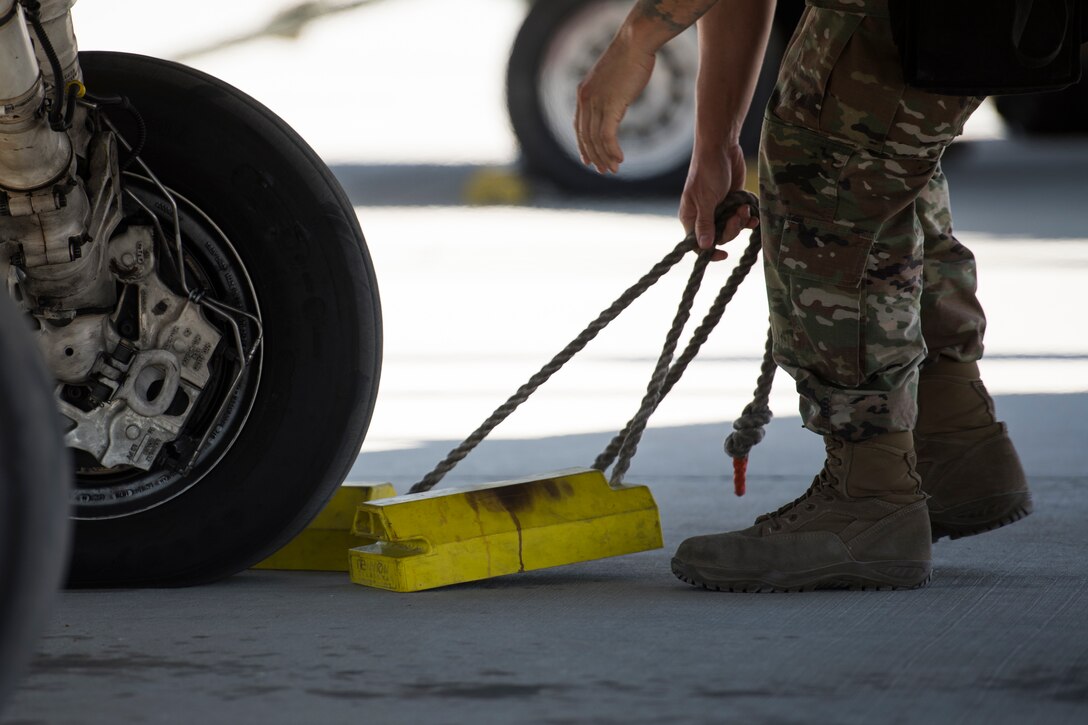 A U.S. Air Force Airman with the 380th Expeditionary Aircraft Maintenance Squadron removes chalks from under a U.S. Air Force F-16 “Viper” Fighting Falcons assigned to the 79th Expeditionary Fighter Squadron at an undisclosed location in the U.S. Central Command area of responsibility, Feb. 24, 2020.