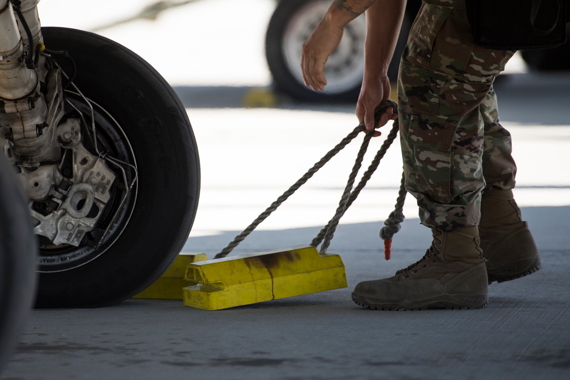 A U.S. Air Force Airman with the 380th Expeditionary Aircraft Maintenance Squadron removes chalks from under a U.S. Air Force F-16 “Viper” Fighting Falcons assigned to the 79th Expeditionary Fighter Squadron at an undisclosed location in the U.S. Central Command area of responsibility, Feb. 24, 2020.