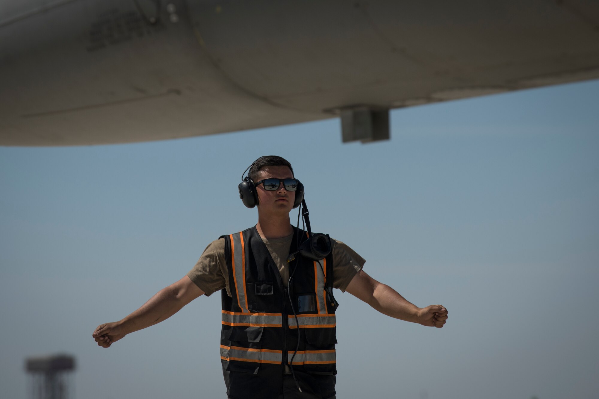 U.S Air Force Airman 1st Class Michael Tobat, a crew chief with the 380th Expeditionary Aircraft Maintenance Squadron, waits to marshal a U.S. Air Force F-16 “Viper” Fighting Falcon assigned to the 79th Expeditionary Fighter Squadron at an undisclosed location in the U.S. Central Command area of responsibility, Feb. 24, 2020.
