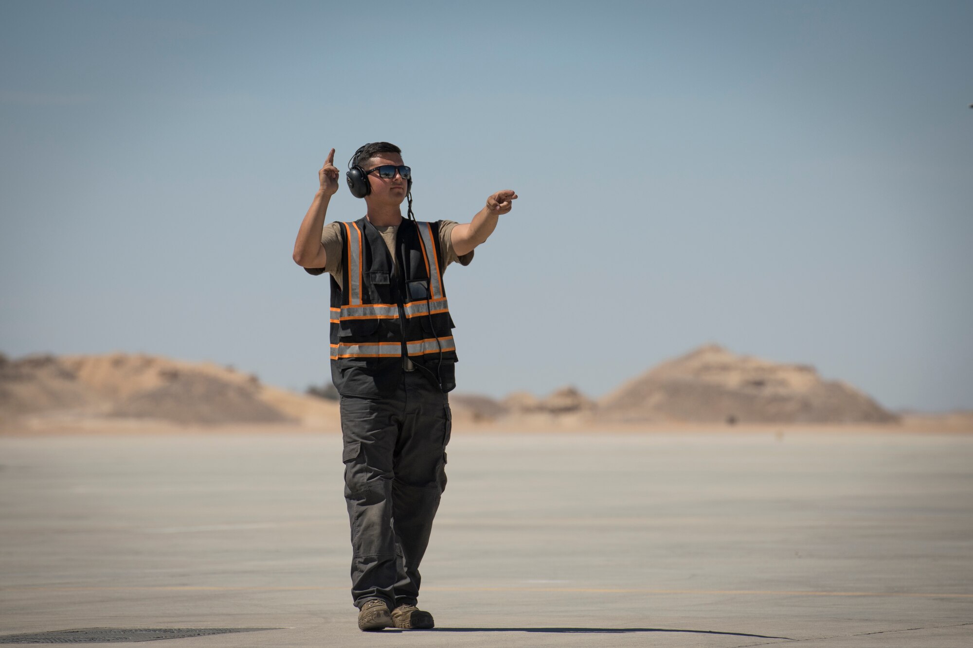 U.S Air Force Airman 1st Class Michael Tobat, a crew chief with the 380th Expeditionary Aircraft Maintenance Squadron, marshals a U.S. Air Force F-16 “Viper” Fighting Falcon assigned to the 79th Expeditionary Fighter Squadron at an undisclosed location in the U.S. Central Command area of responsibility, Feb. 24, 2020.