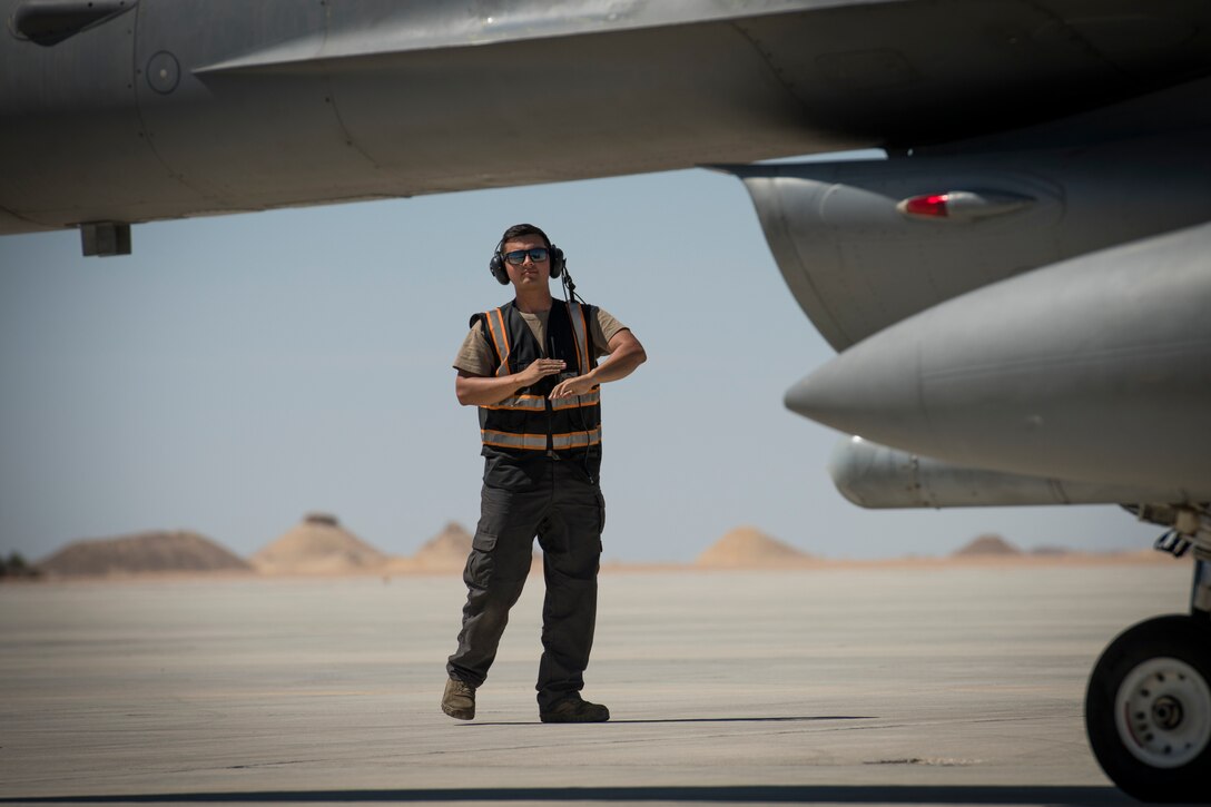 U.S Air Force Airman 1st Class Michael Tobat, a crew chief with the 380th Expeditionary Aircraft Maintenance Squadron, marshals a U.S. Air Force F-16 “Viper” Fighting Falcon assigned to the 79th Expeditionary Fighter Squadron at an undisclosed location in the U.S. Central Command area of responsibility, Feb. 24, 2020.