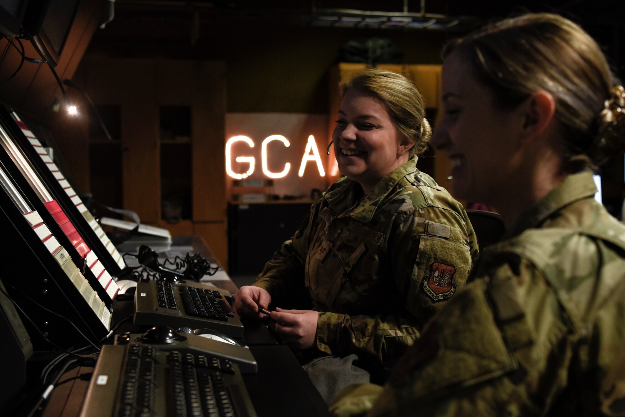U.S. Air Force Staff Sgts. Kelly Laws, left, and Ashley Aring, right, both 52nd Operations Support Squadron Air Traffic Control watch supervisors, operate Ground Controlled Approach radar equipment at Spangdahlem Air Base, Germany, March 25, 2020. Airmen in the GCA radar facility control aircraft within about 30 miles of the airfield. GCA Airmen also communicate with pilots from NATO countries to make sure the airspace remains safe for all. (U.S. Air Force photo by Senior Airman Valerie R. Seelye)
