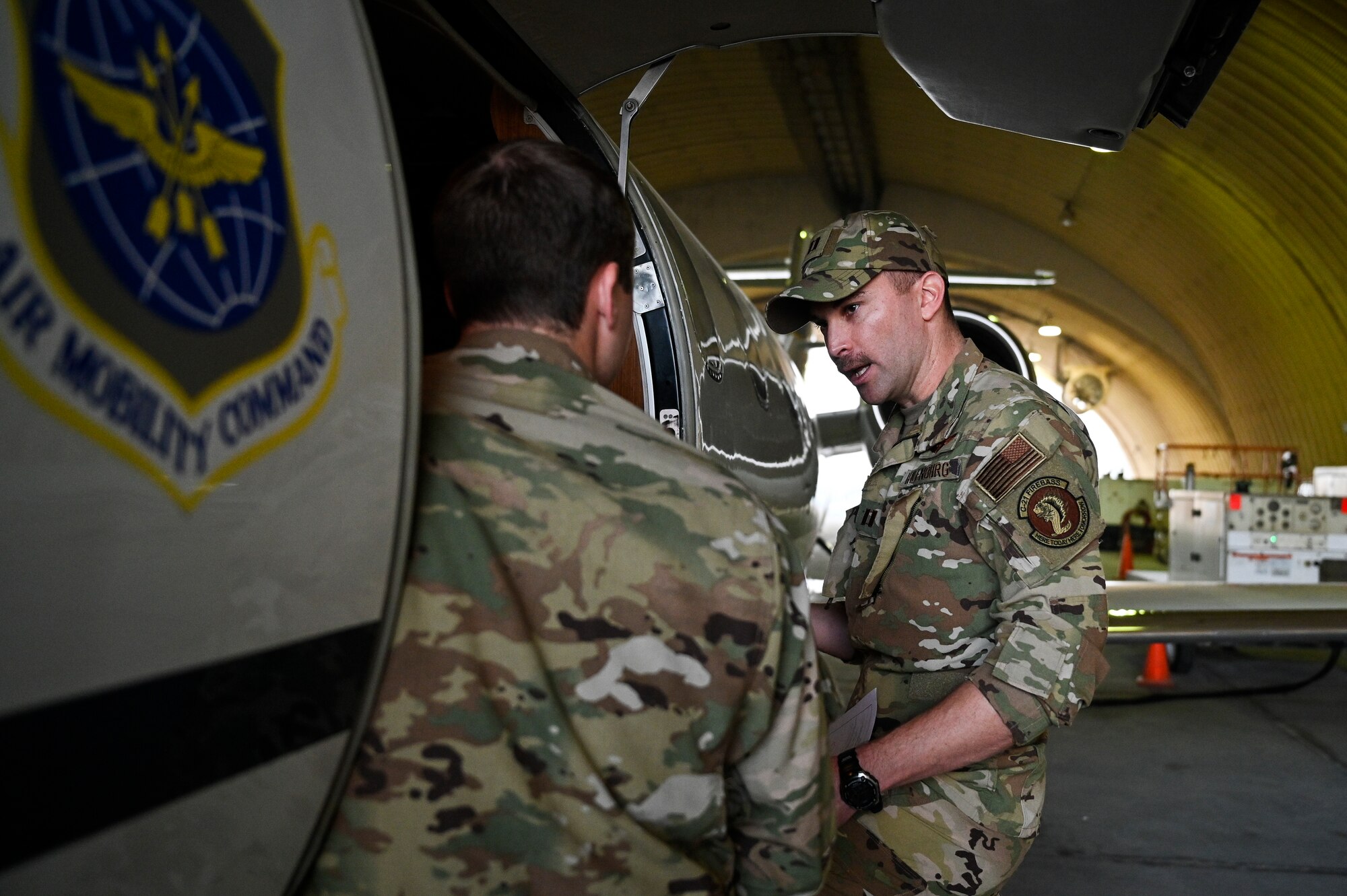 U.S. Air Force 1st Lt. Donald Snediker, left, and U.S. Air Force Capt. Greg Ihlenburg, pilots with the 746th Expeditionary Airlift Squadron deployed to Al Udeid Air Base, Qatar, prepare for a C-21 flight at AUAB, Feb. 24, 2020.