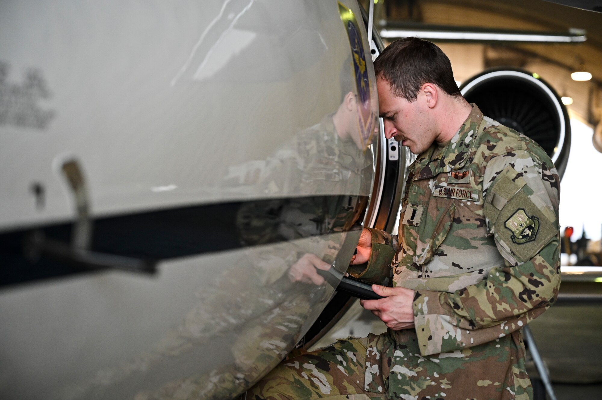 U.S. Air Force 1st Lt. Donald Snediker, a pilot with the 746th Expeditionary Airlift Squadron deployed to Al Udeid Air Base, Qatar, prepare for a C-21 flight at AUAB, Feb. 24, 2020.