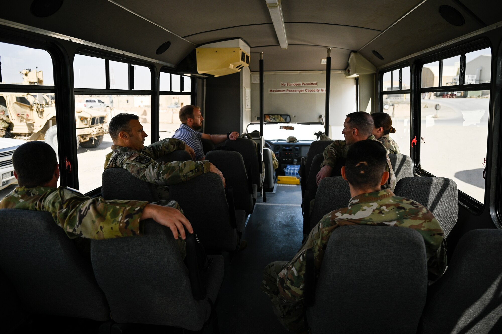 U.S. Air Force Lt. Gen. Joseph T. Guastella, Jr., Commander, U.S. Air Forces Central Command and Combined Forces Air Component Commander, and U.S. Air Force Chief Master Sgt. Shawn L. Drinkard, Command Chief Master Sgt. for USAFCENT, ride a bus on Kandahar Airfield, Afghanistan during a visit to the 451st Air Expeditionary Group, based at KAF to talk about the importance of the USAFCENT mission in Afghanistan, Feb. 24, 2020.