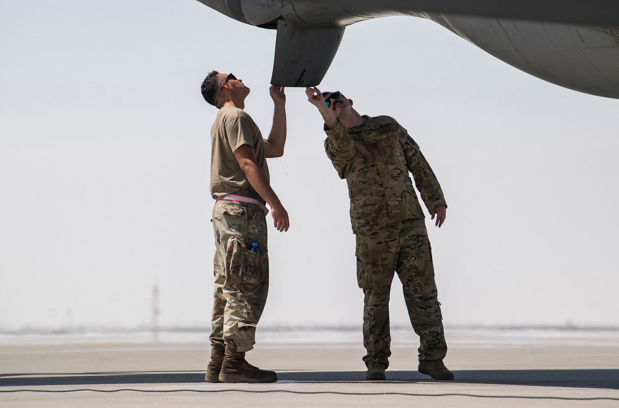 U.S. Air Force Airmen assigned to the 28th Expeditionary Air Refueling Squadron, perform a preflight check on a U.S. Air Force KC-135 Stratotanker at Al Udeid Air Base, Qatar, March 11, 2020.