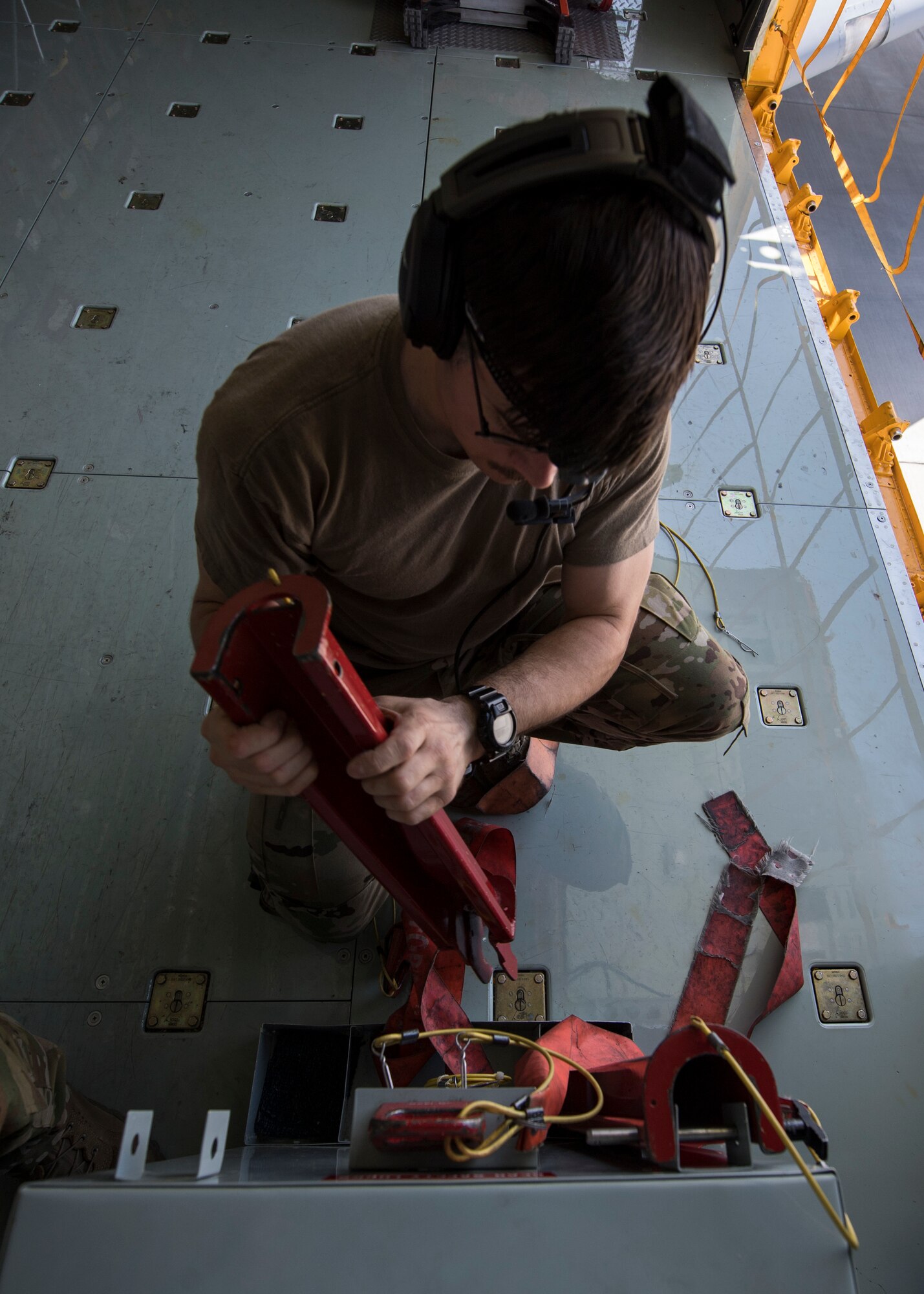 U.S. Air Force Tech. Sgt. David Foglietti, a 28th Expeditionary Air Refueling Squadron in-flight refueling specialist, ties down equipment aboard a U.S. Air Force KC-135 Stratotanker, at Al Udeid Air Base, Qatar, March 11, 2020.