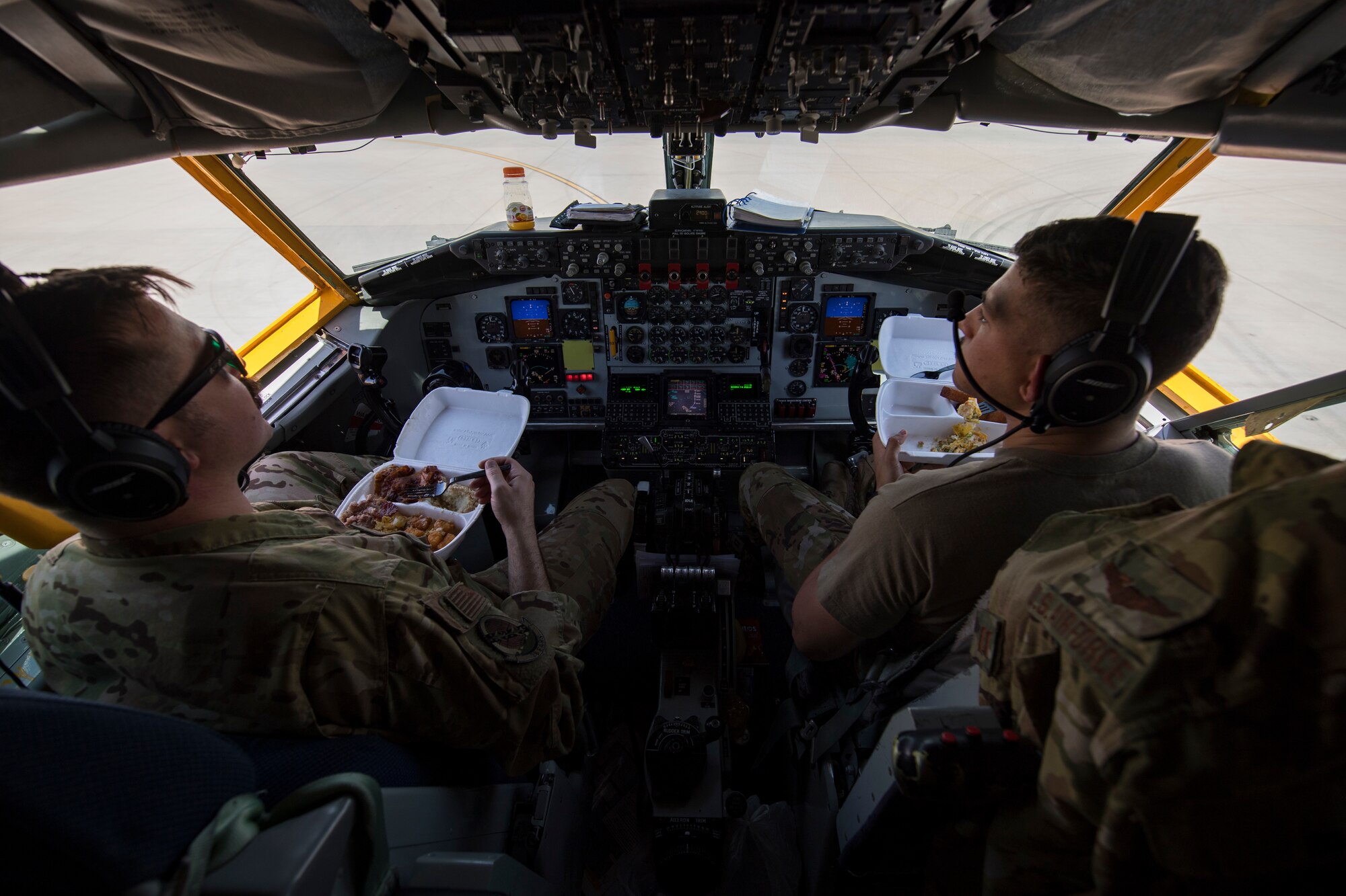 U.S. Air Force Capts. Michael Lowe, left, and Kamden Collotzi, 28th Expeditionary Air Refueling Squadron pilots, eat breakfast before preflight checks on a U.S. Air Force KC-135 Stratotanker at Al Udeid Air Base, Qatar, March 11, 2020.