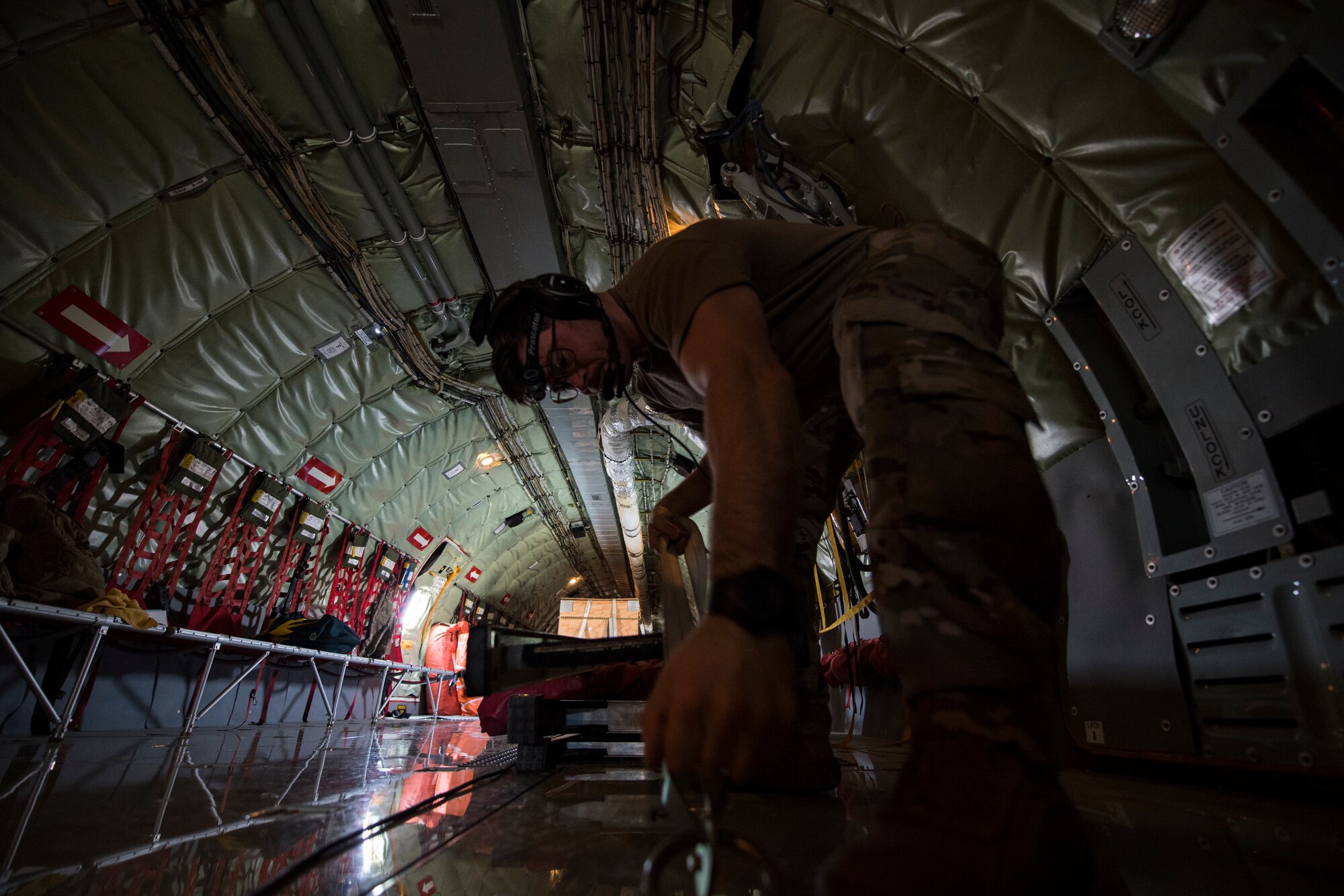U.S. Air Force Tech. Sgt. David Foglietti, a 28th Expeditionary Air Refueling Squadron in-flight refueling specialist, ties down equipment aboard a U.S. Air Force KC-135 Stratotanker, at Al Udeid Air Base, Qatar, March 11, 2020.