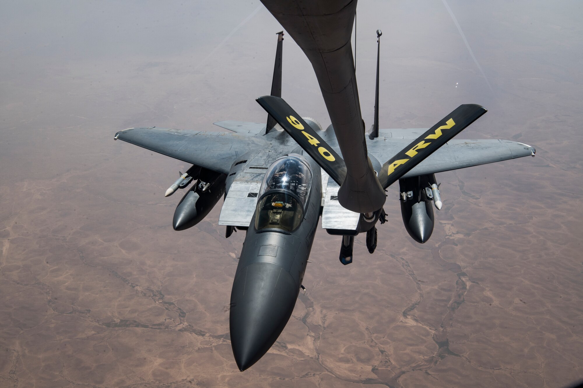 A U.S. Air Force F-15E Strike Eagle approaches a U.S. Air Force KC-135 Stratotanker assigned to the 28th Expeditionary Air Refueling Squadron, to conduct an aerial refueling over Iraq, March 11, 2020.