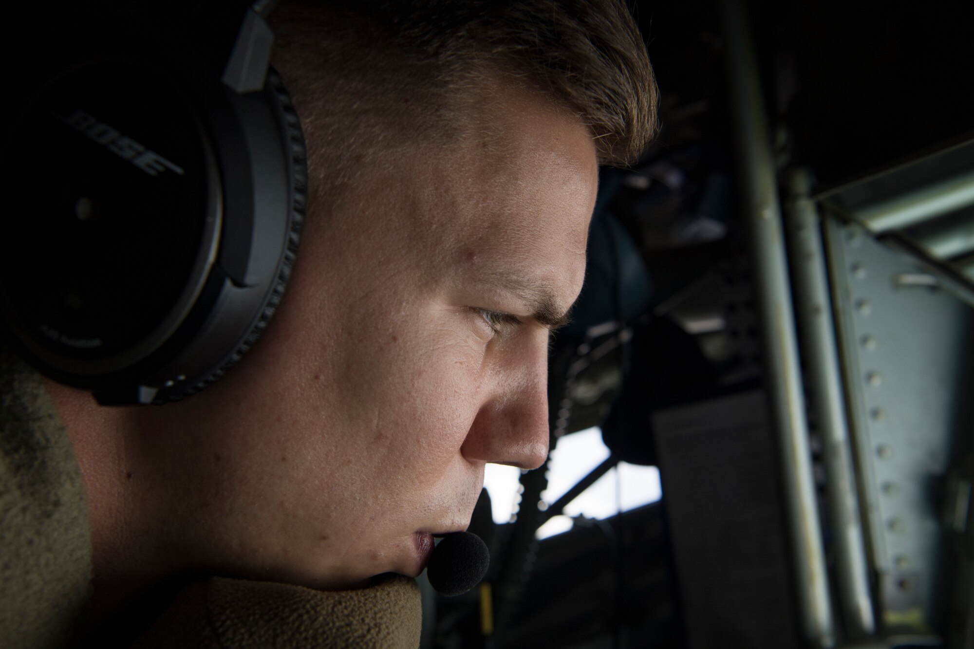 U.S. Air Force Airman 1st Class Andrew Bain, a 28th Expeditionary Air Refueling Squadron in-flight refueling specialist, performs an aerial refueling over Afghanistan, March 17, 2020.