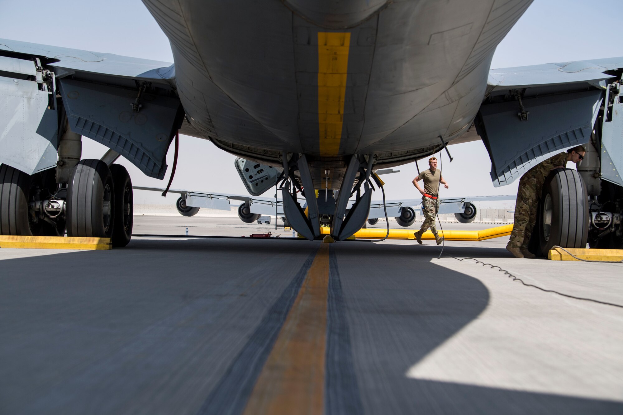 U.S. Air Force Capt. Kelsey Glover, right, a 28th Expeditionary Air Refueling Squadron pilot, and a crew chief perform a preflight check on a U.S. Air Force KC-135 Stratotanker at Al Udeid Air Base, Qatar, March 17, 2020.