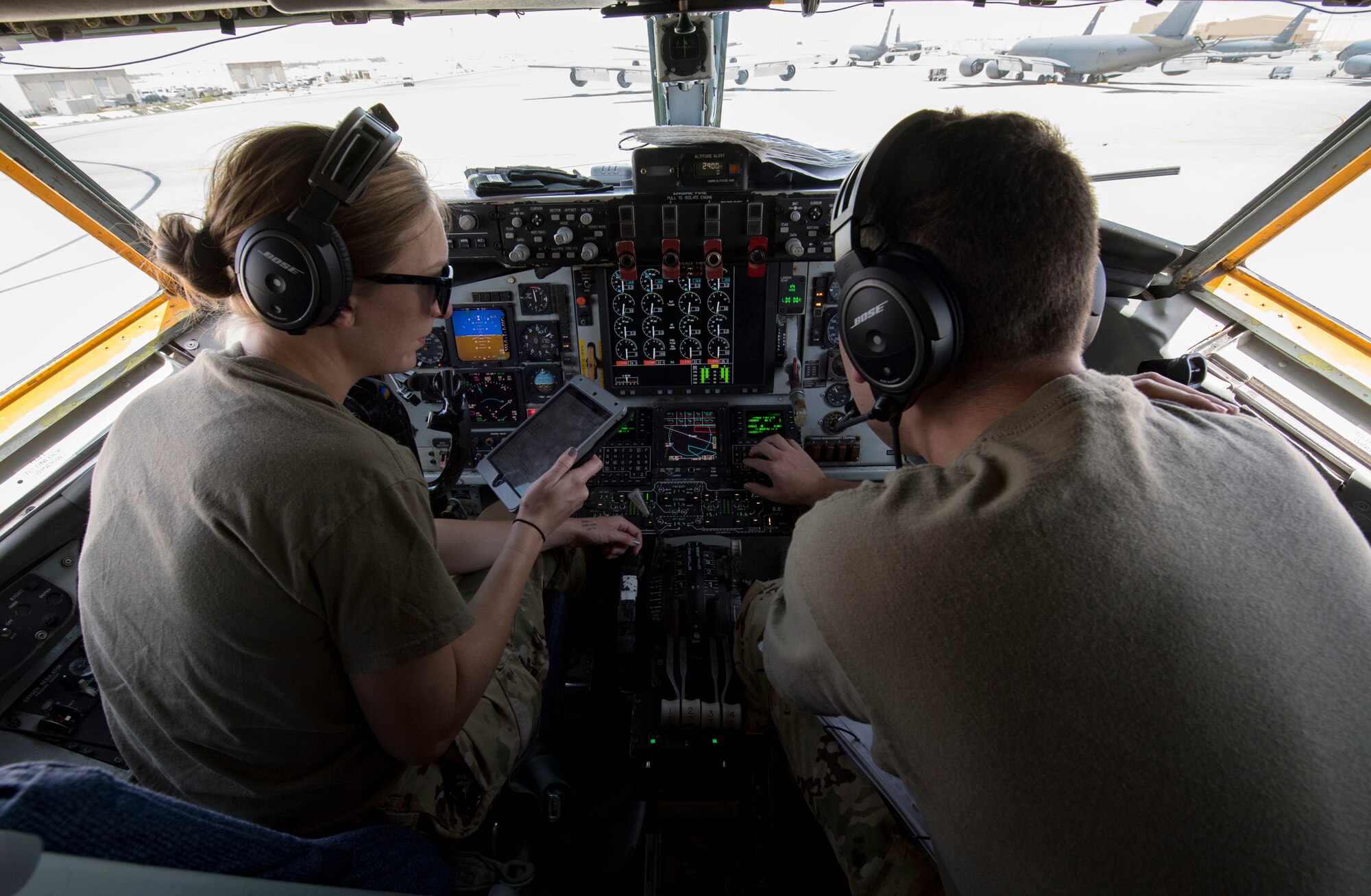 U.S. Air Force Capts. Kelsey Glover, left, and Gavin Delphia, 28th Expeditionary Air Refueling Squadron pilots, perform a preflight check on a U.S. Air Force KC-135 Stratotanker at Al Udeid Air Base, Qatar, March 17, 2020.