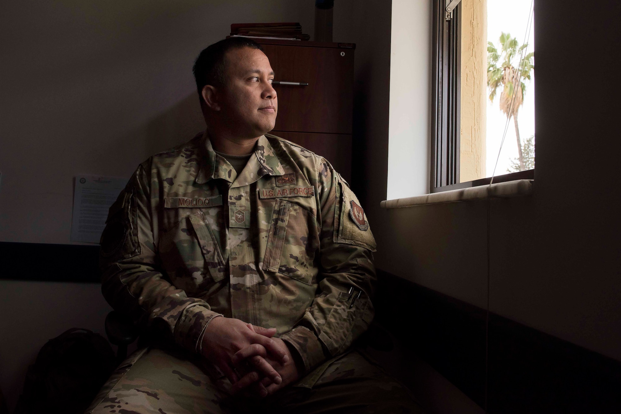 U.S. Air Force Master Sgt. Teve Molioo, 39th Communications Squadron first sergeant, stares out of a window, March 31, 2020, at Incirlik Air Base, Turkey. As a first sergeant, Molioo advises his commander on matters of good order and discipline, as well as providing the commander with the pulse of morale and welfare in the unit. (U.S. Air Force photo by Staff Sgt. Joshua Magbanua)