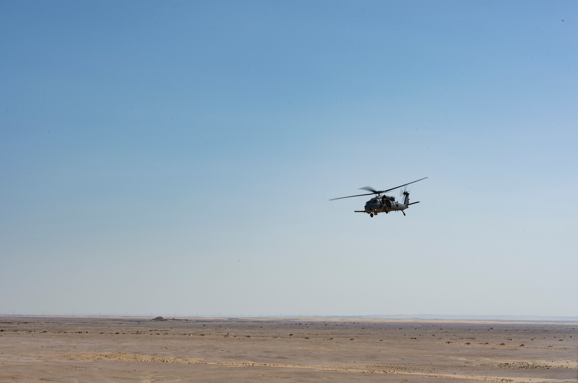 A U.S. Air Force HH-60G Pave Hawk assigned to the 66th Expeditionary Rescue Squadron conducts a training exercise near Al Udeid Air Base, Qatar, March 24, 2020.