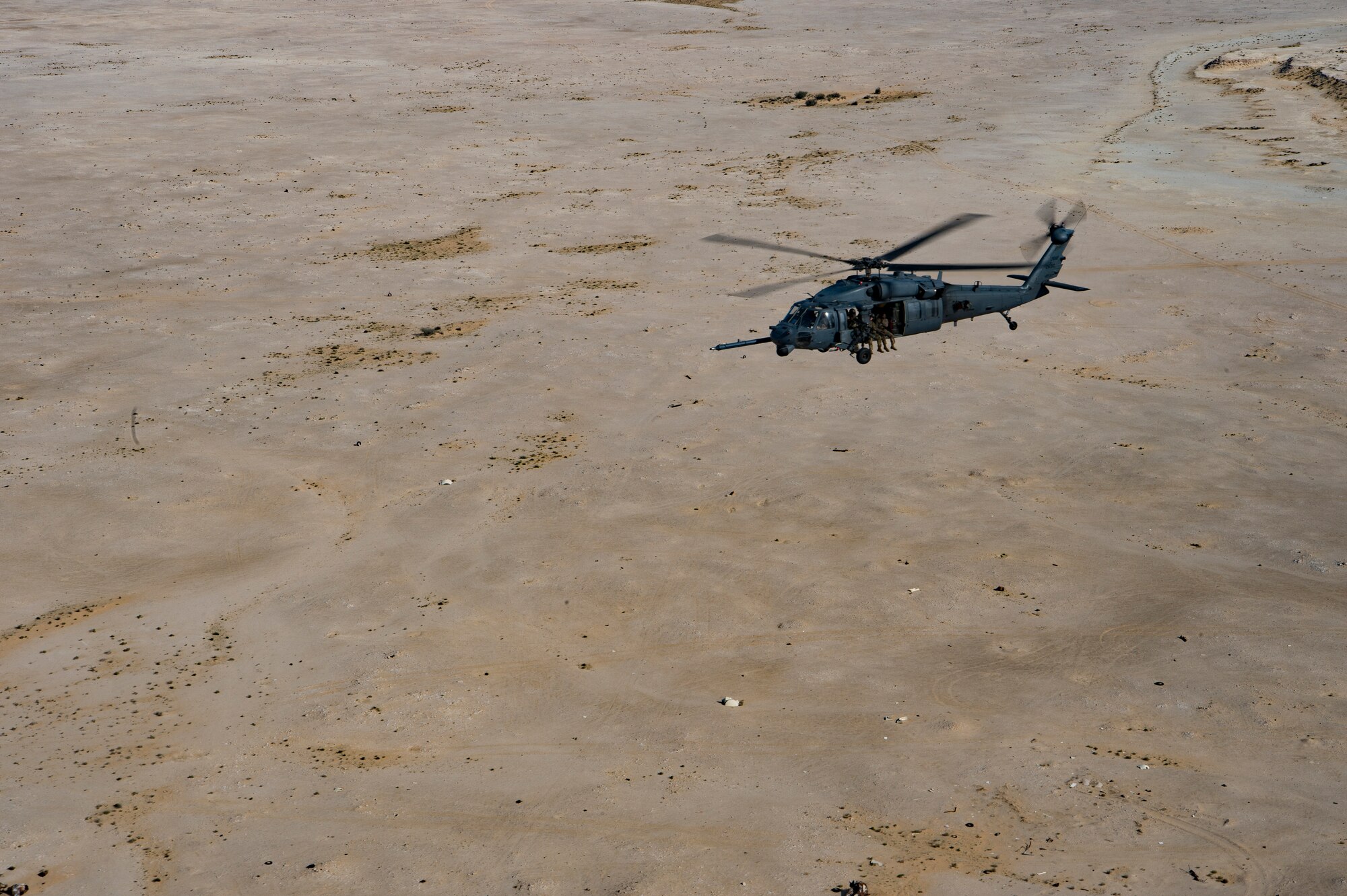 A U.S. Air Force HH-60G Pave Hawk assigned to the 66th Expeditionary Rescue Squadron conducts a training exercise near Al Udeid Air Base, Qatar, March 24, 2020.