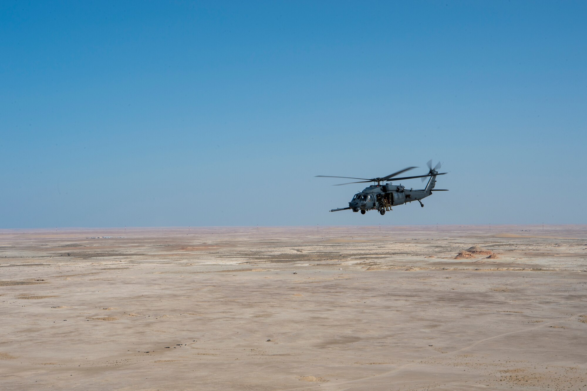 A U.S. Air Force HH-60G Pave Hawk assigned to the 66th Expeditionary Rescue Squadron conducts a training exercise near Al Udeid Air Base, Qatar, March 24, 2020.