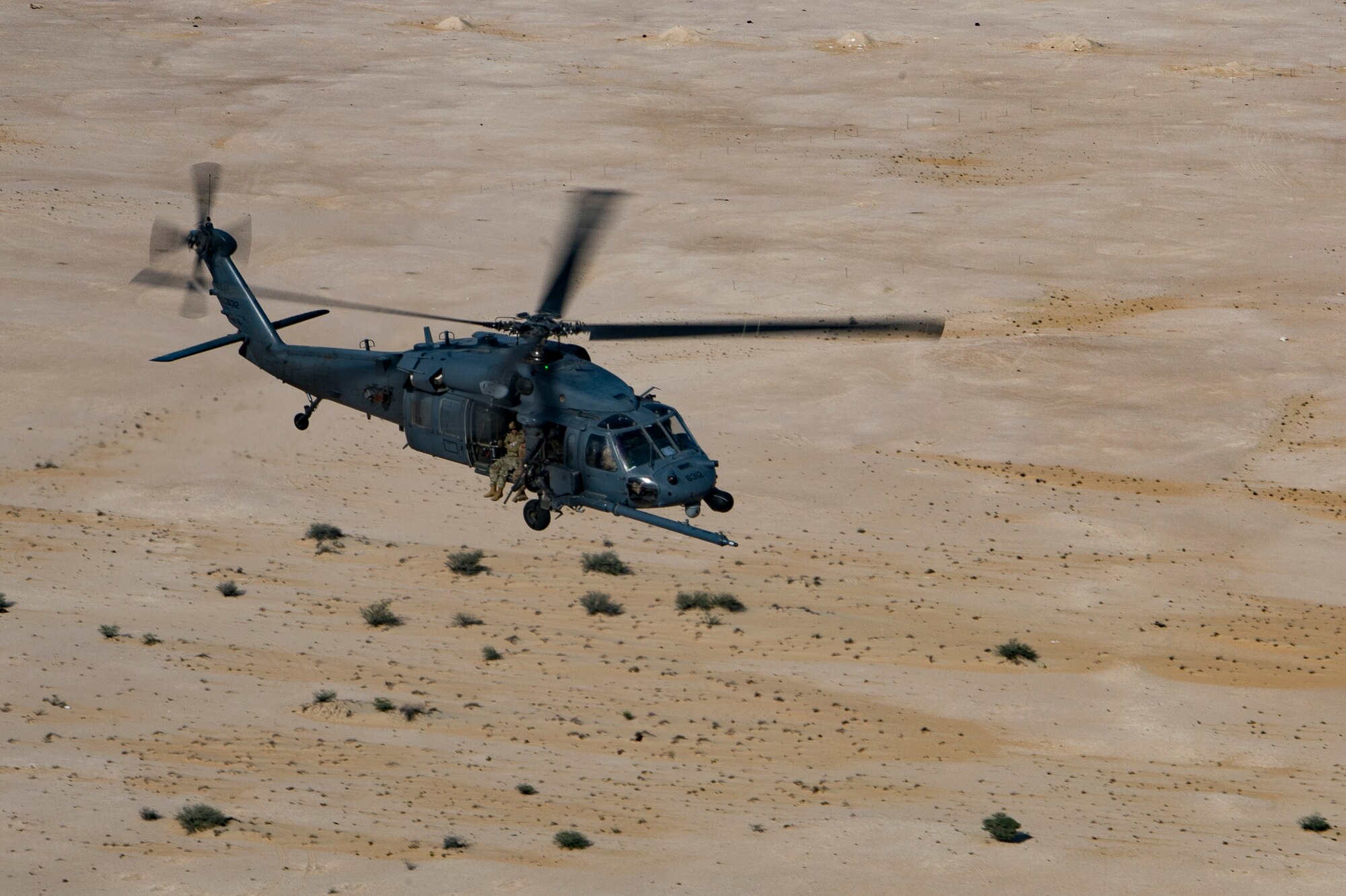 A U.S. Air Force HH-60G Pave Hawk assigned to the 66th Expeditionary Rescue Squadron conducts a training exercise near Al Udeid Air Base, Qatar, March 24, 2020.