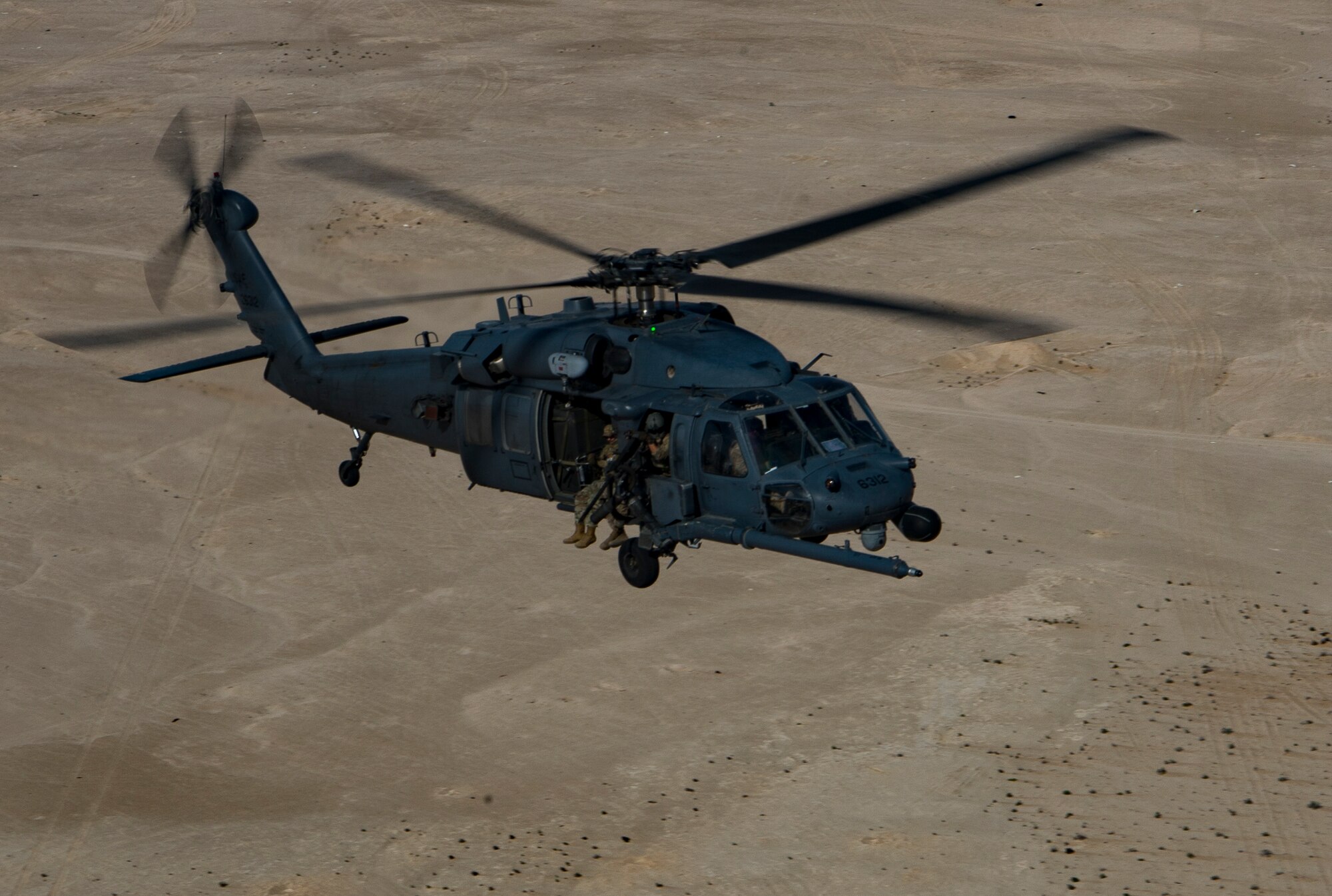 A U.S. Air Force HH-60G Pave Hawk assigned to the 66th Expeditionary Rescue Squadron conducts a training exercise near Al Udeid Air Base, Qatar, March 24, 2020.