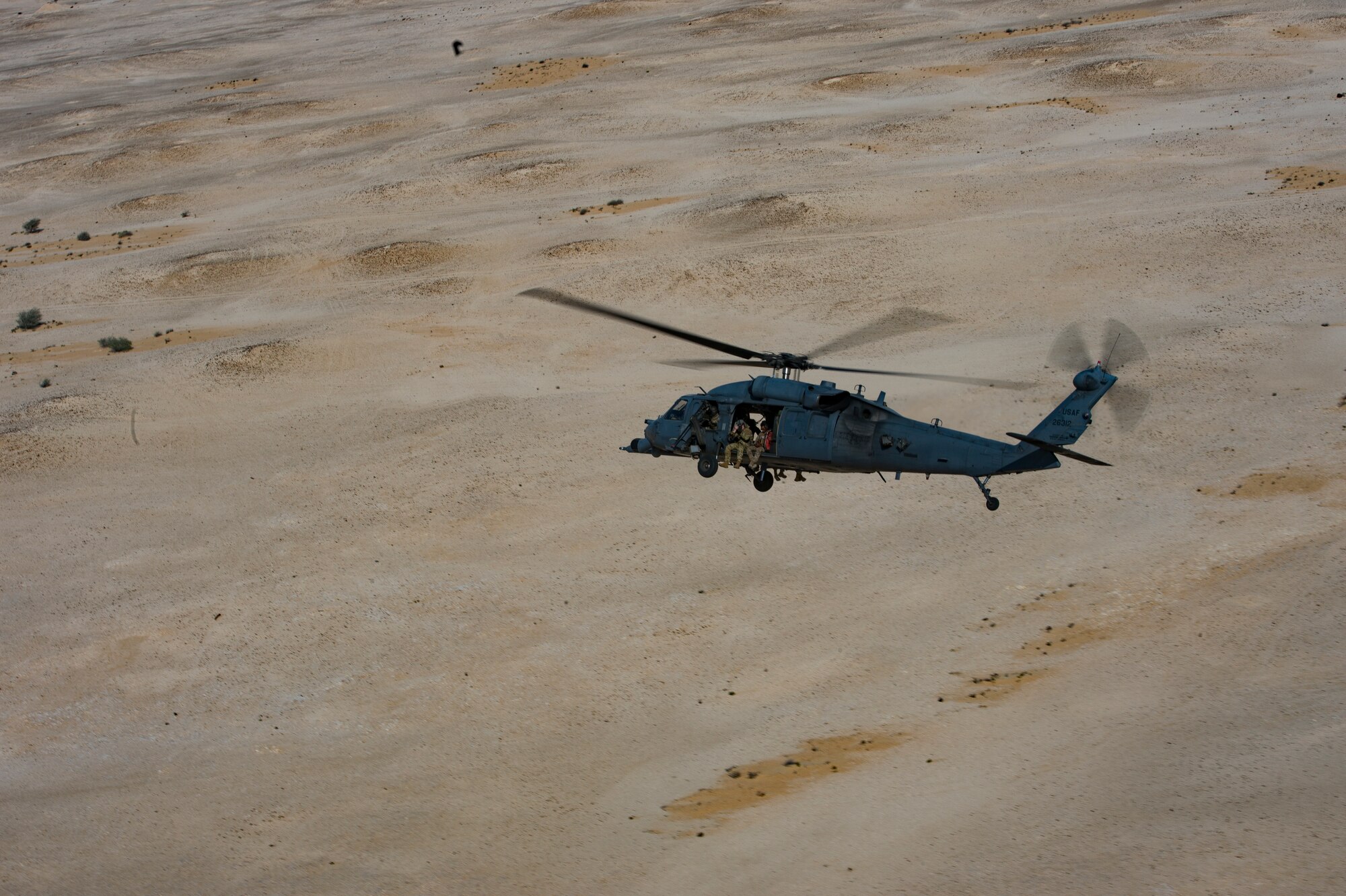 A U.S. Air Force HH-60G Pave Hawk assigned to the 66th Expeditionary Rescue Squadron conducts a training exercise near Al Udeid Air Base, Qatar, March 24, 2020.