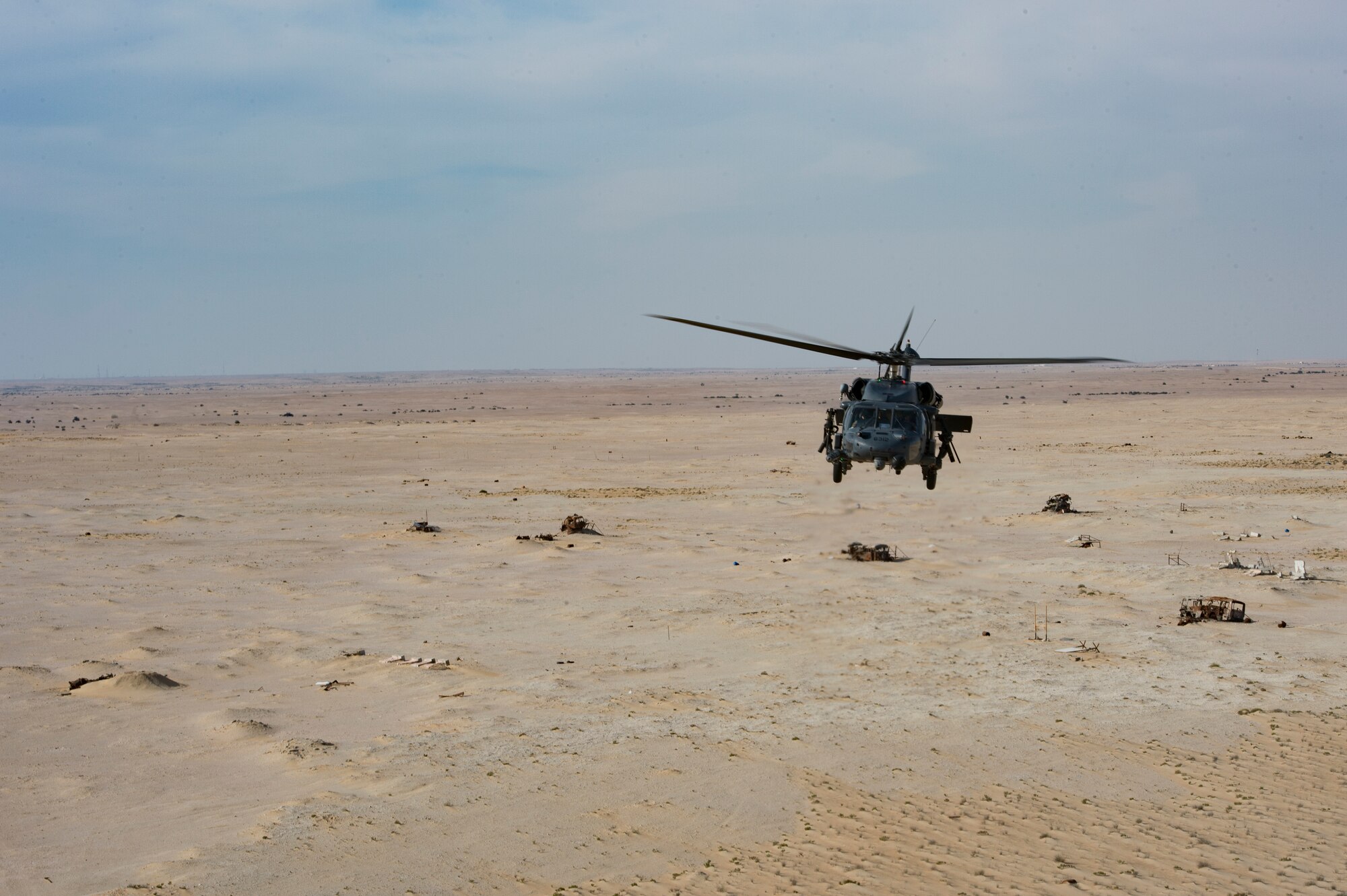 A U.S. Air Force HH-60G Pave Hawk assigned to the 66th Expeditionary Rescue Squadron conducts a training exercise near Al Udeid Air Base, Qatar, March 24, 2020.