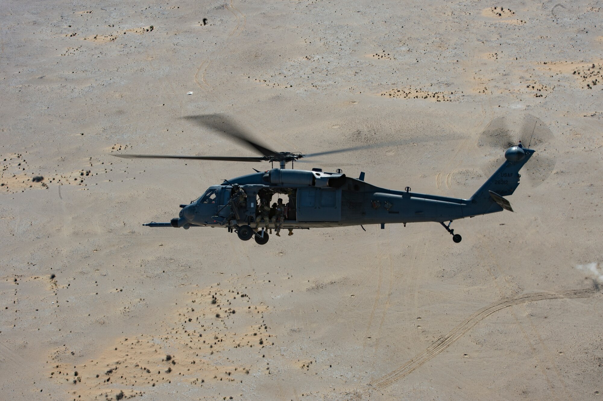 A U.S. Air Force HH-60G Pave Hawk assigned to the 66th Expeditionary Rescue Squadron conducts a training exercise near Al Udeid Air Base, Qatar, March 24, 2020.