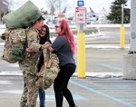 Staff Sgt. Steven Finch, an infantryman assigned to Bravo Company, 1st Battalion, 297th Infantry Regiment, Alaska Army National Guard, greets his loved ones at Ted Stevens International Airport, Apr. 4, 2020. Finch returned from a deployment to Kosovo for a NATO peacekeeping mission.