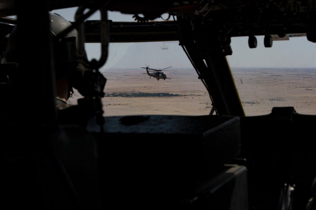 Two U.S. Air Force HH-60G Pave Hawk assigned to the 66th Expeditionary Rescue Squadron conducts a training exercise near Al Udeid Air Base, Qatar, March 24, 2020.