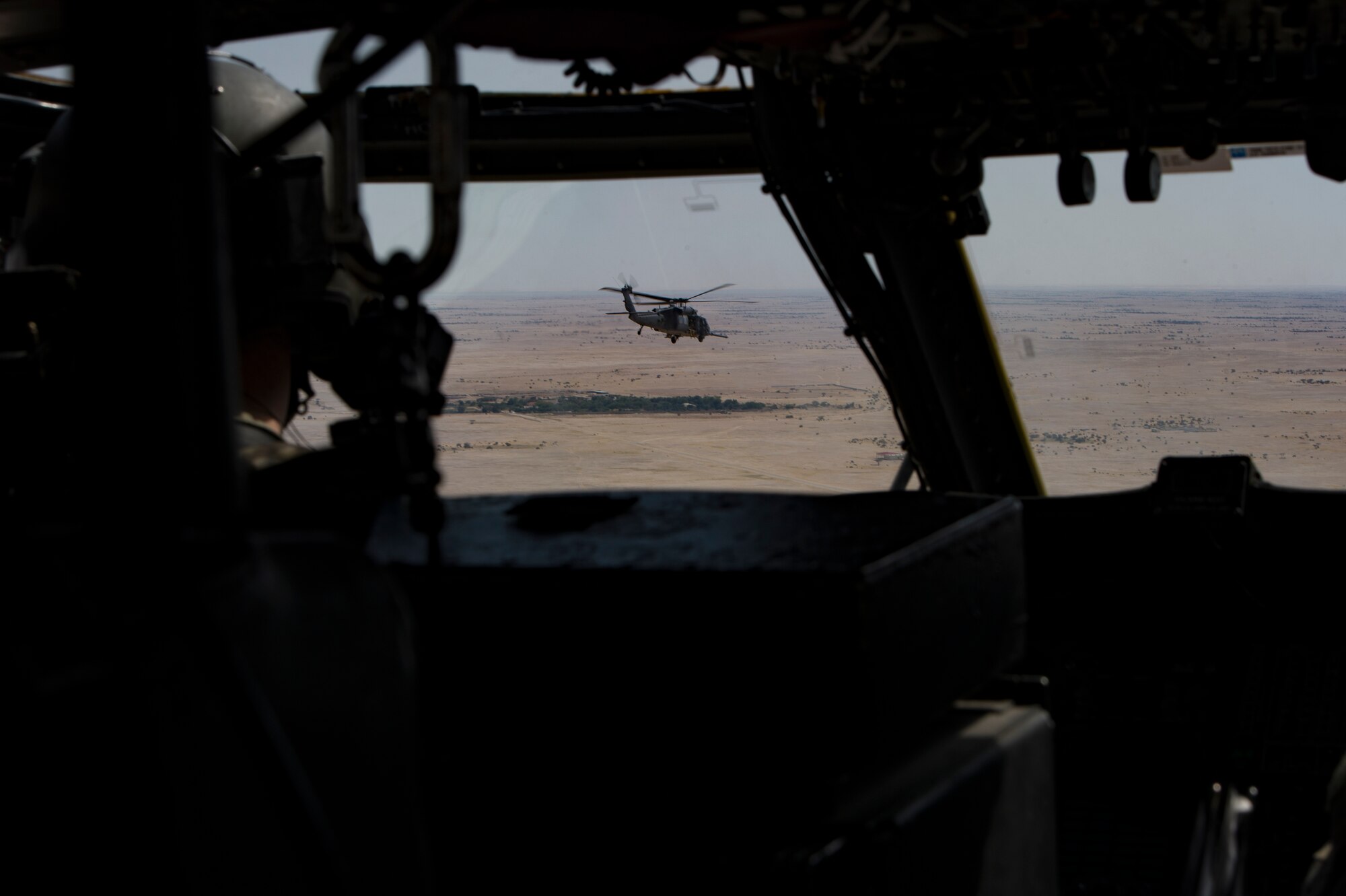 Two U.S. Air Force HH-60G Pave Hawk assigned to the 66th Expeditionary Rescue Squadron conducts a training exercise near Al Udeid Air Base, Qatar, March 24, 2020.
