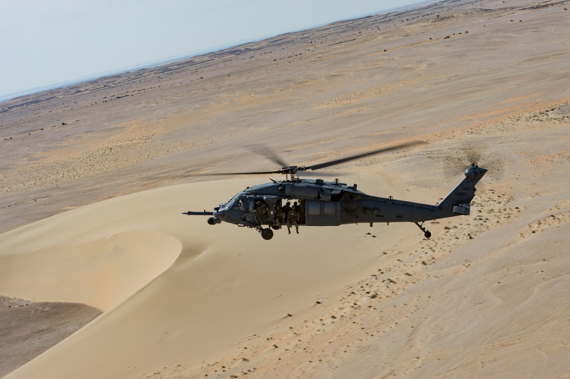 A U.S. Air Force HH-60G Pave Hawk assigned to the 66th Expeditionary Rescue Squadron conducts a training exercise near Al Udeid Air Base, Qatar, March 24, 2020.