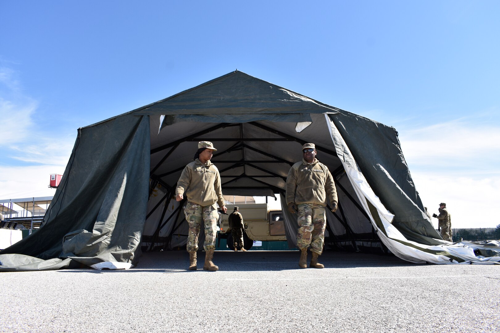 Members of the Maryland Army National Guard’s 1297th Combat Sustainment Support Battalion and 1729th Maintenance Company, both based in Havre de Grace, and the 1229th Transportation Company, based in Baltimore, set up shelters and medium tents at a COVID-19 test site in a parking lot outside of Pimlico Race Course in Baltimore April 3, 2020.