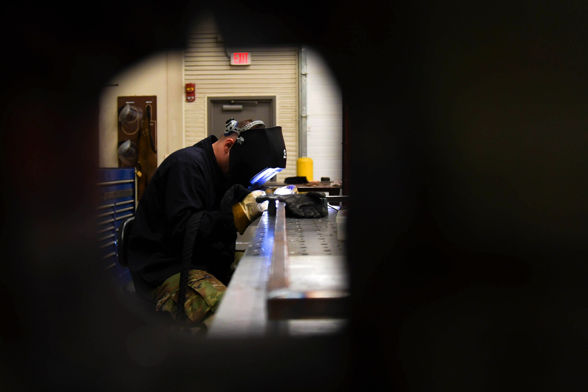 Staff Sgt. Derrick Wilkins, 22nd Maintenance Squadron aircraft metals technology craftsman, welds the seams of two metal rods of a sewage grate cover March 24, 2020, at McConnell Air Force Base, Kansas. Metals technicians are highly trained to use a variety of advanced machinery to produce and repair Team McConnell’s aircraft and equipment. (U.S. Air Force photo by Airman 1st Class Nilsa E. Garcia)