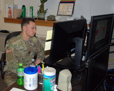 New York Army National Guard Staff Sgt. Timothy Fogarty monitors the situation in the New York National Guard Joint Operations Center in Latham,  March 18, 2020. The Joint Operations Center, or JOC, serves as the central clearing point for operational information to allow Maj. Gen. Ray Shields, the adjutant general of New York, to control the response as the force assists in New York State efforts to control the COVID-19 pandemic.