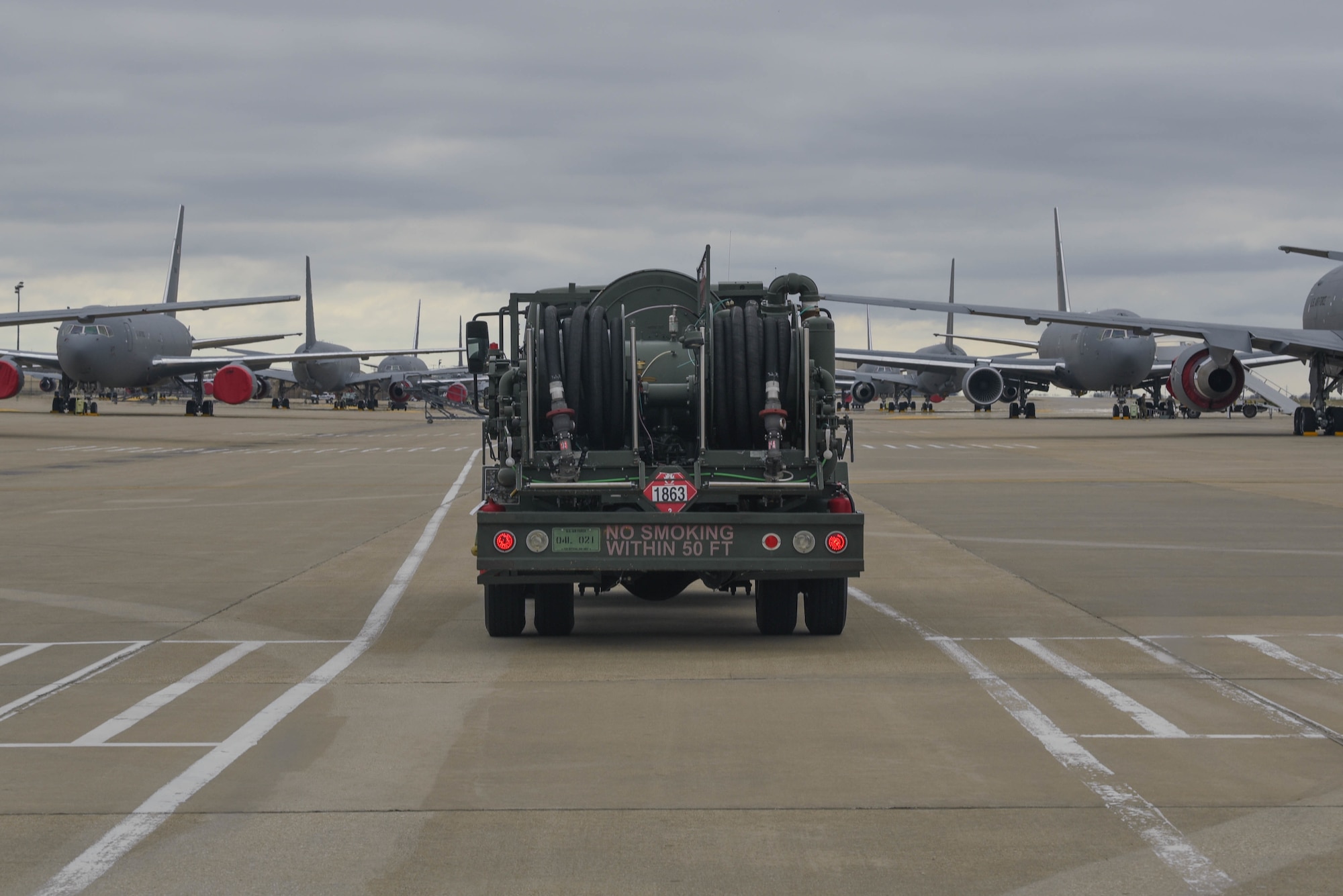 A petroleum, oil and lubricants truck drives to refuel a KC-46 Pegasus on the flightline March 24, 2020, at McConnell Air Force Base, Kansas. POL services McConnell’s 55 aircraft and offloads approximately 75,000 gallons of Jet A fuel daily supporting aerial refueling operations. (U.S. Air Force photo by Senior Airman Alexi Bosarge)