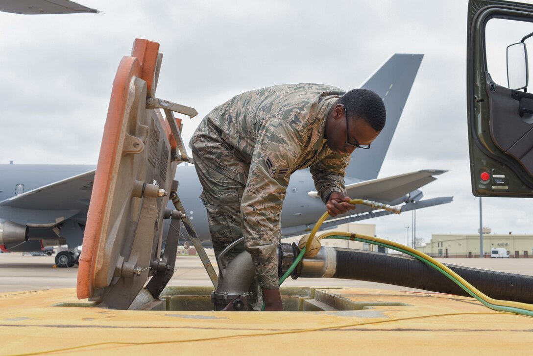 Airman 1st Class Jeremiah Epps, 22nd Logistic Readiness Squadron fuels distribution operator, hooks up air and fuel sensing lines March 24, 2020, at McConnell Air Force Base, Kansas. The connection allows the Epps to control the fuel transfer pressure and flow rates during refueling operations. (U.S. Air Force photo by Senior Airman Alexi Bosarge)