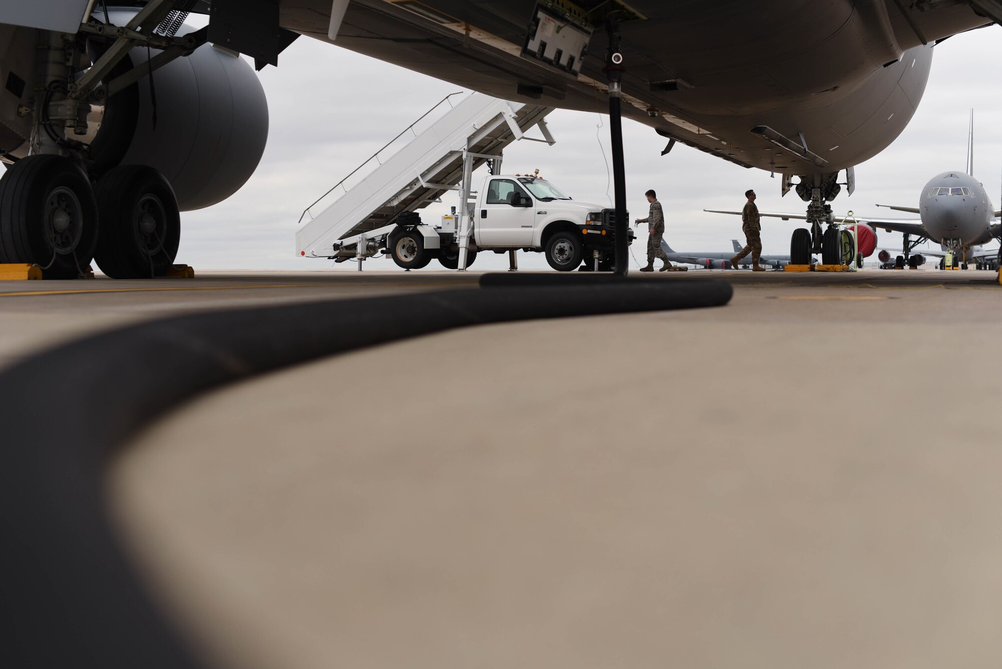 A fuel hose transfers Jet A fuel to a KC-46 Pegasus March 24, 2020, at McConnell Air Force Base, Kansas. Fuel trucks are capable of delivering 50,000 pounds of fuel at a rate of 2,000 pounds per minute. Additionally, petroleum, oil and lubricants are responsible for conducting fuel sampling quality control analysis to verify Jet A fuel is free of contaminants. (U.S. Air Force photo by Senior Airman Alexi Bosarge)