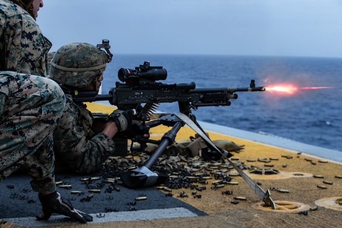 A Marine fires an M240B medium machine gun during a full mission profile defense of the amphibious task force exercise aboard amphibious assault ship USS America (LHA 6).